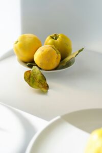 yellow ripe quince fruit with green leaves